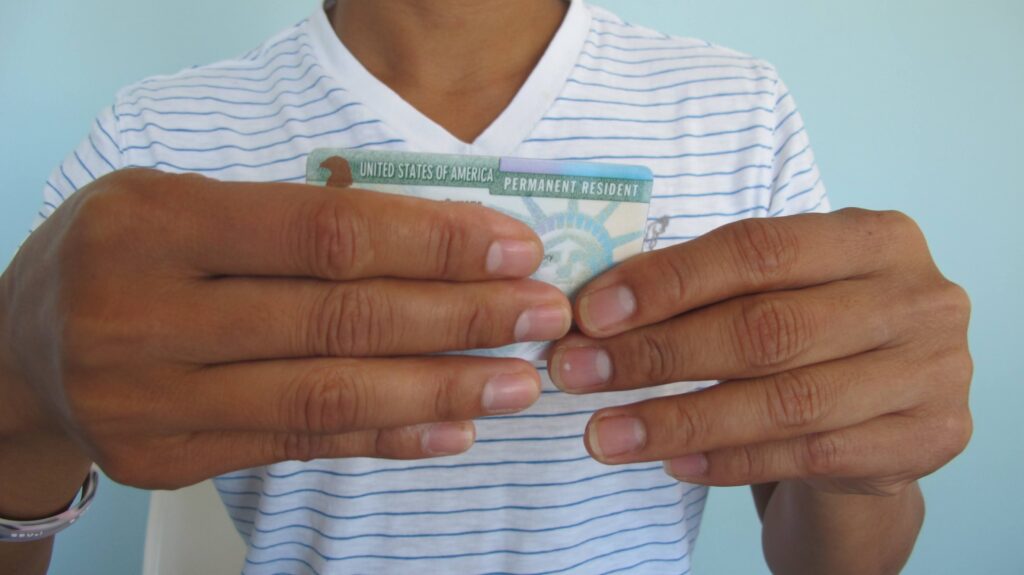 person holding a United States of American Permanent Resident card