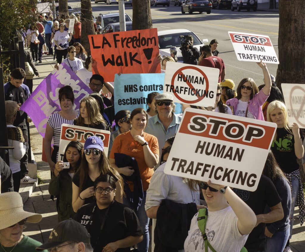 Group of people holding stop human trafficking signs