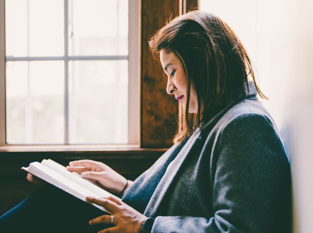 woman reading in front of a window